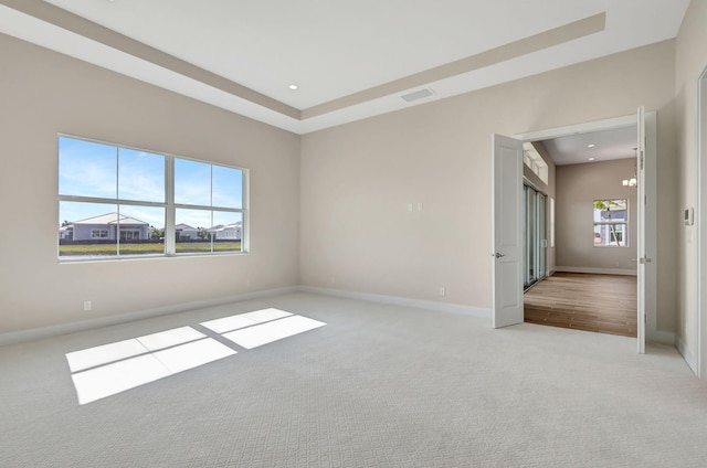 spare room with carpet floors, recessed lighting, baseboards, and visible vents