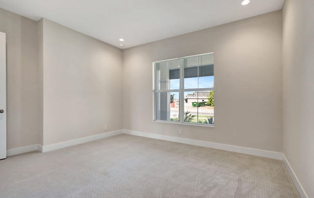 empty room featuring baseboards, carpet flooring, and recessed lighting