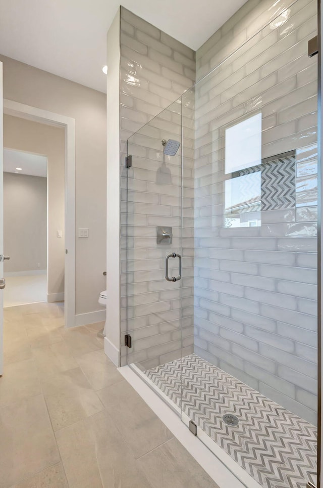 full bathroom featuring toilet, tile patterned floors, recessed lighting, baseboards, and a stall shower