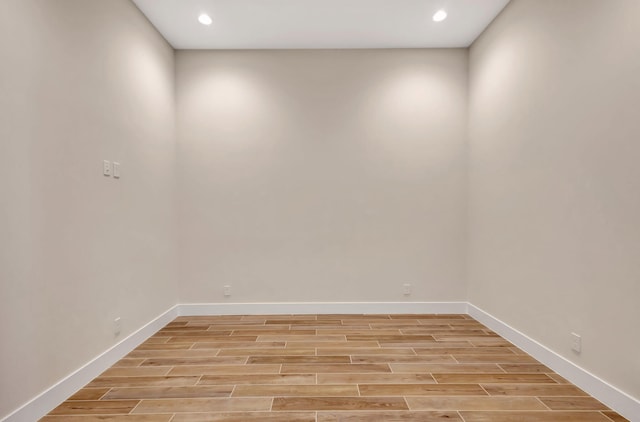 unfurnished room with light wood-style floors, recessed lighting, and baseboards