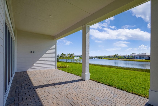 view of patio featuring a residential view and a water view