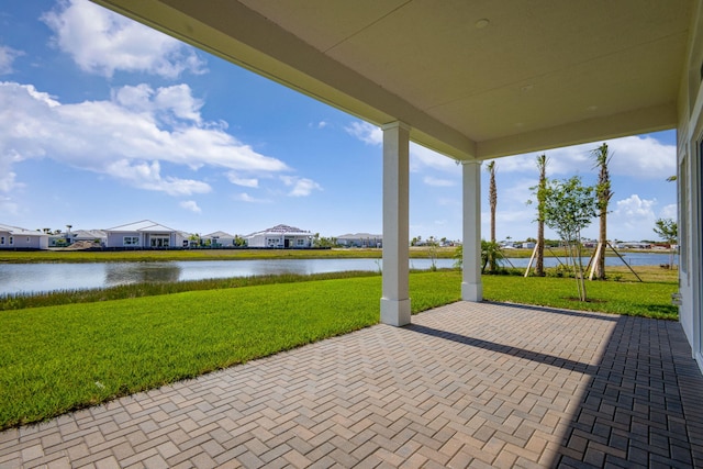 view of patio / terrace with a water view and a residential view