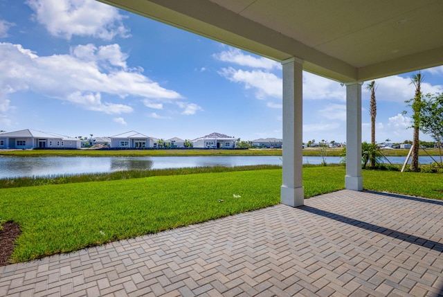view of patio / terrace featuring a residential view and a water view