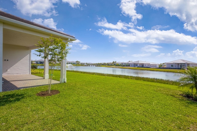 view of yard featuring a residential view and a water view