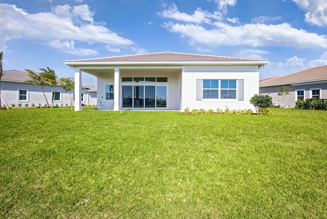 rear view of property with a yard