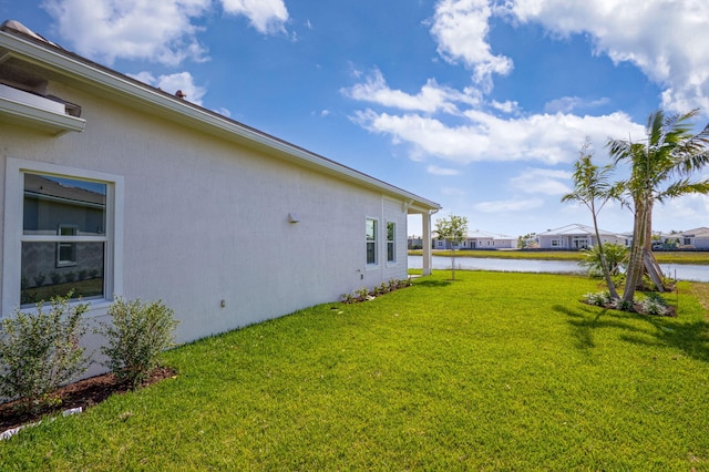 view of yard featuring a residential view and a water view