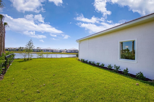 view of yard with a water view and a residential view