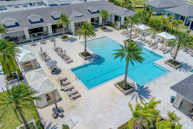 pool with a patio and fence