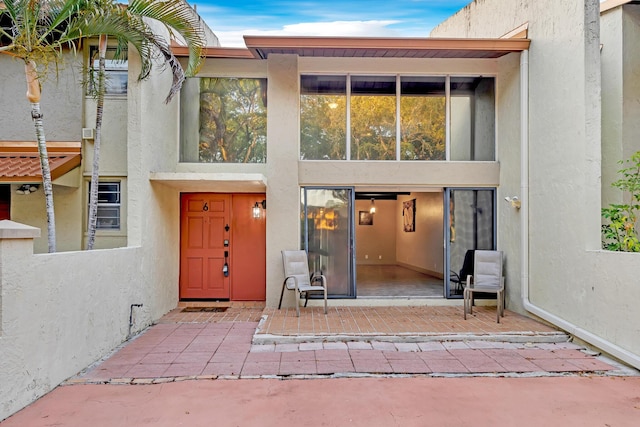 exterior space with a patio and stucco siding