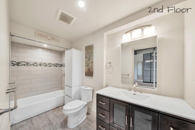 bathroom featuring toilet, visible vents,  shower combination, and vanity