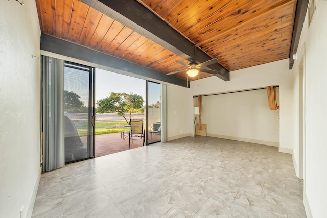 unfurnished room with a ceiling fan, baseboards, marble finish floor, wood ceiling, and beam ceiling