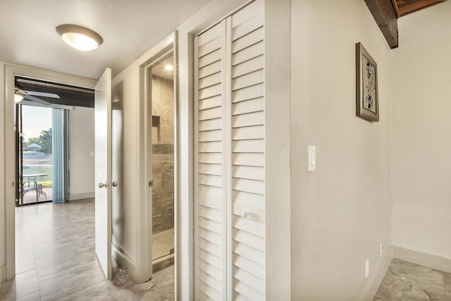 corridor featuring baseboards