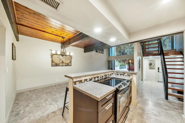 kitchen featuring stainless steel range with electric stovetop, wood ceiling, a kitchen breakfast bar, pendant lighting, and baseboards