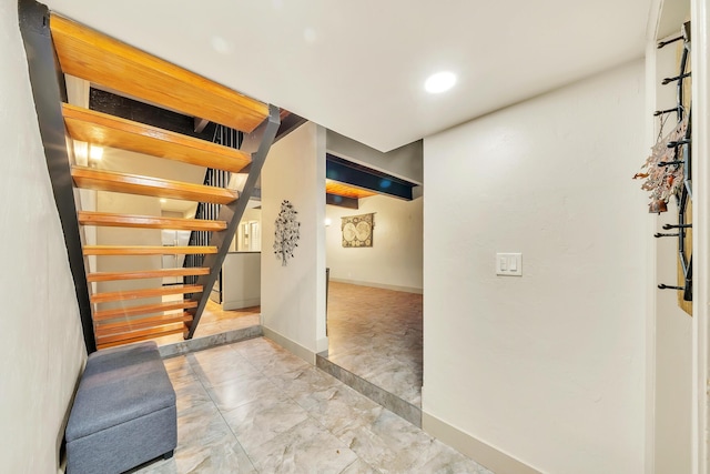 corridor with stairway, baseboards, marble finish floor, and recessed lighting