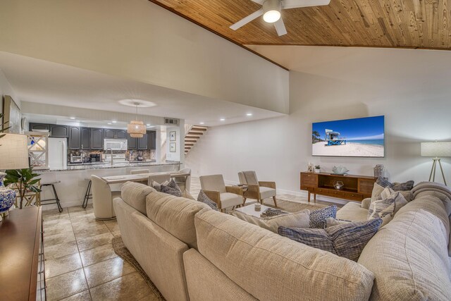 living area featuring ceiling fan, wood ceiling, baseboards, and high vaulted ceiling