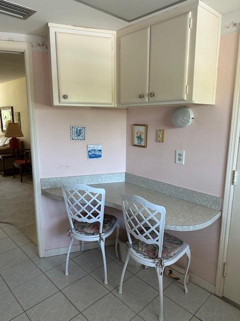331 Tequesta Dr Unit 212, Tequesta, FL 33469 - kitchen with light tile patterned floors and light countertops