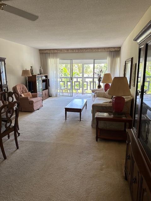 331 Tequesta Dr Unit 212, Tequesta, FL 33469 - living area featuring light colored carpet and a textured ceiling