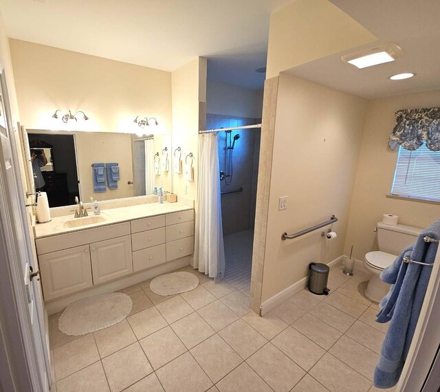 bathroom with vanity, toilet, baseboards, tile patterned flooring, and a shower with shower curtain