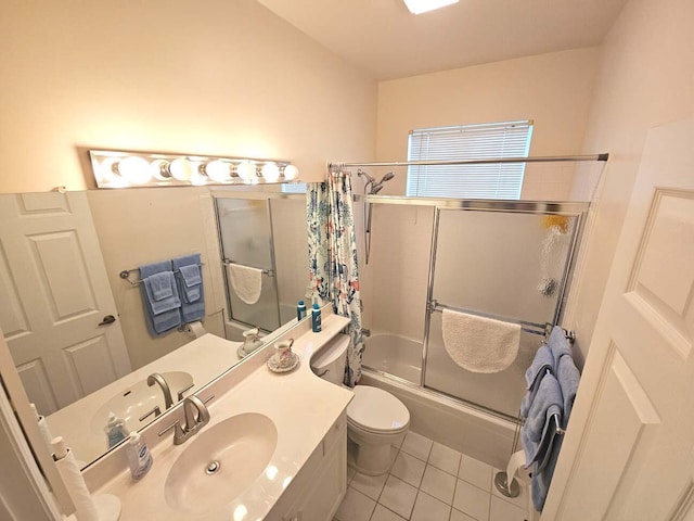bathroom featuring toilet, tile patterned flooring, enclosed tub / shower combo, and vanity
