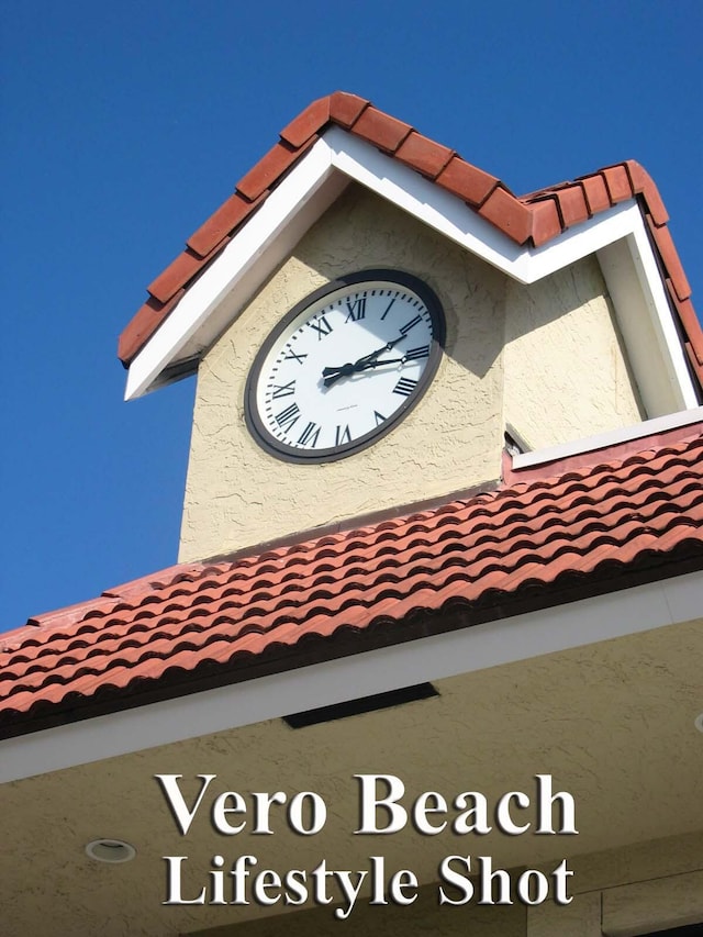 details with stucco siding and a tiled roof