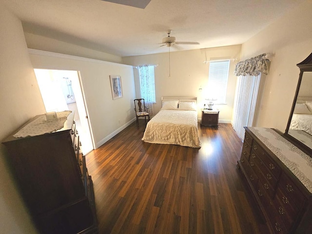 bedroom with dark wood-style floors, baseboards, a ceiling fan, and multiple windows