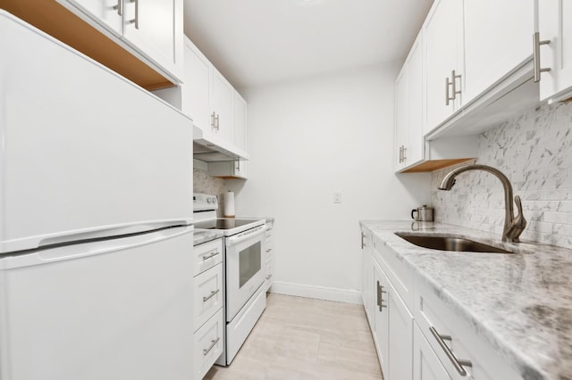 kitchen with a sink, backsplash, under cabinet range hood, and white appliances