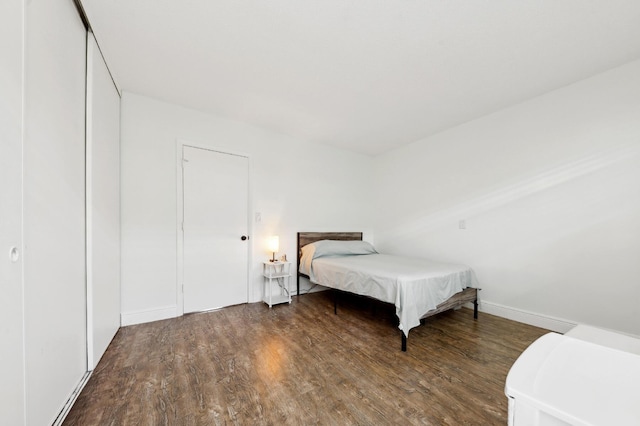bedroom featuring baseboards and wood finished floors