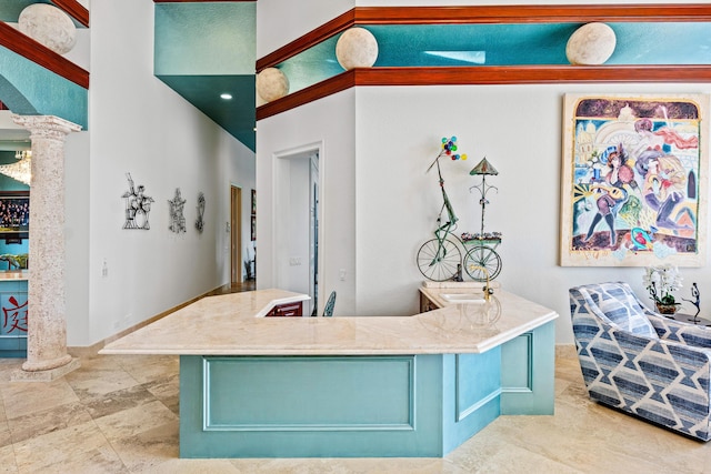 16330 Vintage Oaks Ln, Delray Beach, FL 33484 - kitchen with ornate columns, baseboards, and light countertops