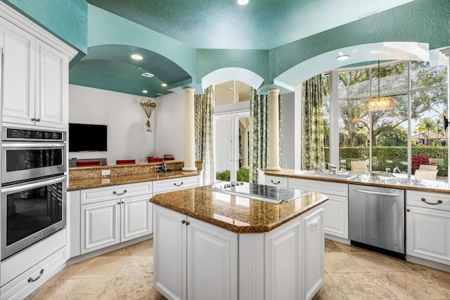 16330 Vintage Oaks Ln, Delray Beach, FL 33484 - kitchen with appliances with stainless steel finishes, a sink, a center island, ornate columns, and white cabinetry