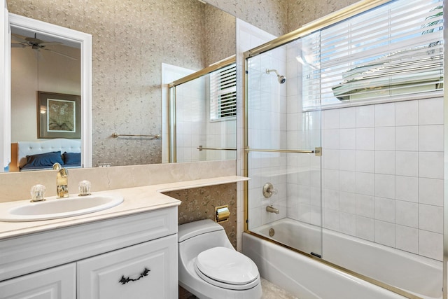 16330 Vintage Oaks Ln, Delray Beach, FL 33484 - full bath featuring wallpapered walls, connected bathroom, combined bath / shower with glass door, toilet, and vanity