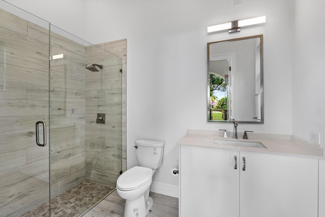 16330 Vintage Oaks Ln, Delray Beach, FL 33484 - bathroom featuring a shower stall, toilet, vanity, and baseboards