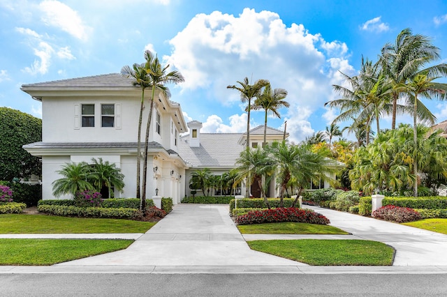 16330 Vintage Oaks Ln, Delray Beach, FL 33484 - view of front of property with driveway, stucco siding, a front lawn, and a tile roof