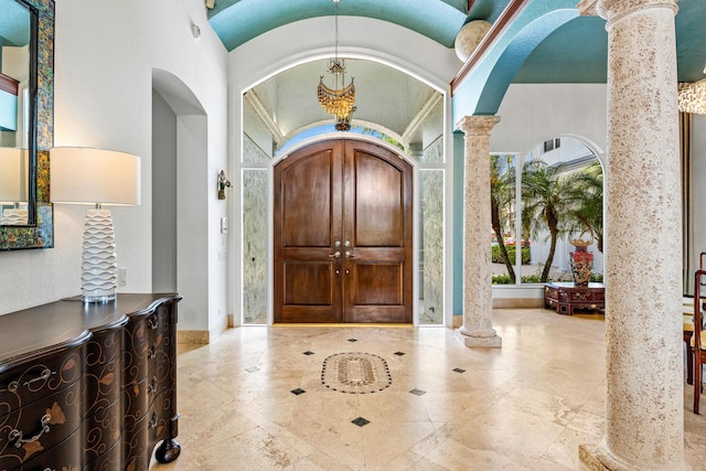 16330 Vintage Oaks Ln, Delray Beach, FL 33484 - foyer entrance featuring decorative columns, arched walkways, and baseboards