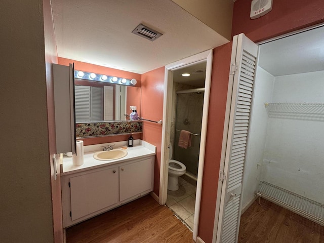 1400 Saint Charles Pl Unit 317, Pembroke Pines, FL 33026 - full bathroom with a closet, toilet, wood finished floors, vanity, and a shower stall