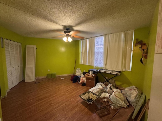 1400 Saint Charles Pl Unit 317, Pembroke Pines, FL 33026 - unfurnished bedroom with wood finished floors, ceiling fan, a textured ceiling, and baseboards