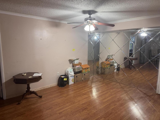 1400 Saint Charles Pl Unit 317, Pembroke Pines, FL 33026 - interior space featuring a textured ceiling, wood finished floors, ornamental molding, a ceiling fan, and baseboards
