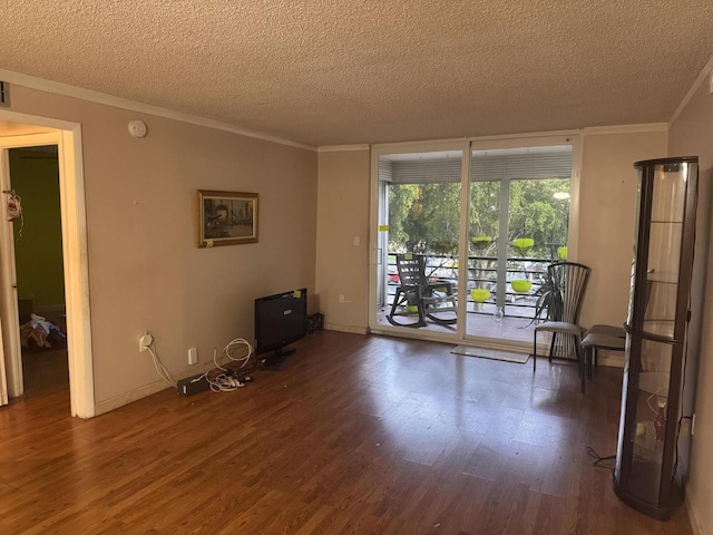 1400 Saint Charles Pl Unit 317, Pembroke Pines, FL 33026 - living room with a textured ceiling, ornamental molding, wood finished floors, and baseboards