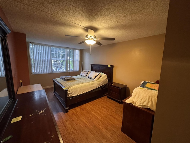 1400 Saint Charles Pl Unit 317, Pembroke Pines, FL 33026 - bedroom featuring wood finished floors, a textured ceiling, ceiling fan, and baseboards