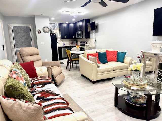 living area featuring recessed lighting, a ceiling fan, and light wood-style floors