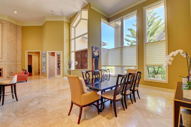 dining area featuring a high ceiling and ornamental molding