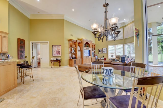 dining area with an inviting chandelier, ornamental molding, a high ceiling, and recessed lighting