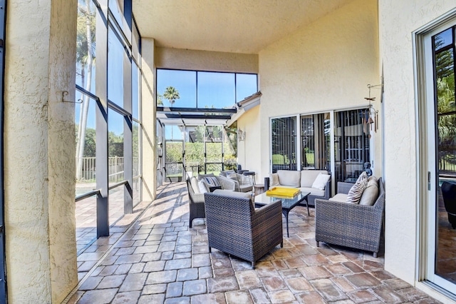 sunroom featuring an outdoor hangout area