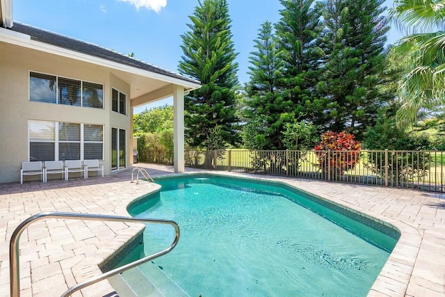 view of pool with fence, a fenced in pool, and a patio