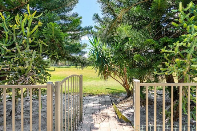view of gate featuring a lawn
