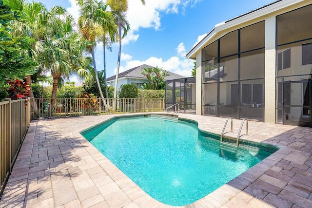 view of swimming pool featuring a patio, fence, a lanai, and a fenced in pool
