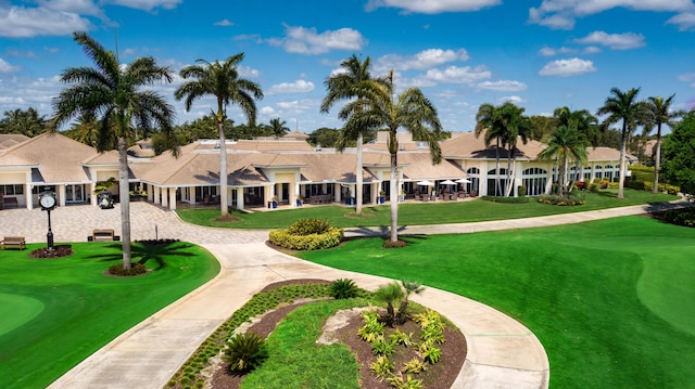 view of property's community with a yard and golf course view