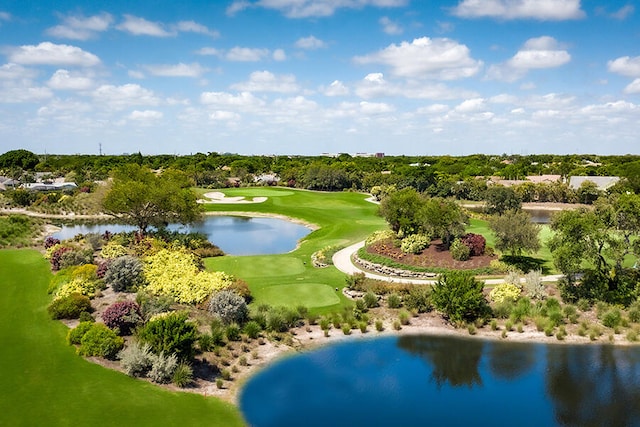 drone / aerial view featuring a water view and golf course view