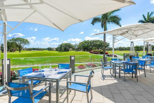 view of patio / terrace featuring outdoor dining area and golf course view