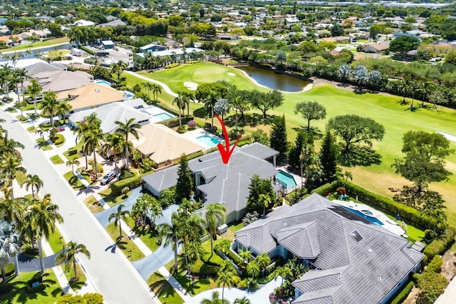 birds eye view of property featuring a water view, view of golf course, and a residential view
