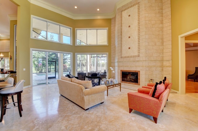 living room with crown molding, plenty of natural light, and a towering ceiling